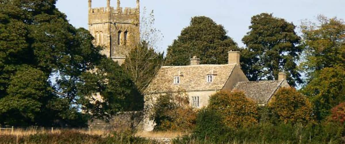 Church Farm, Coates, Gloucestershire, with the tower of St Matthew's parish church beyond