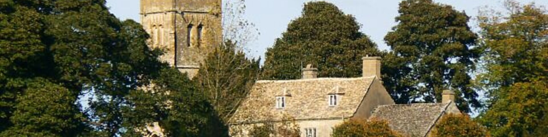 Church Farm, Coates, Gloucestershire, with the tower of St Matthew's parish church beyond
