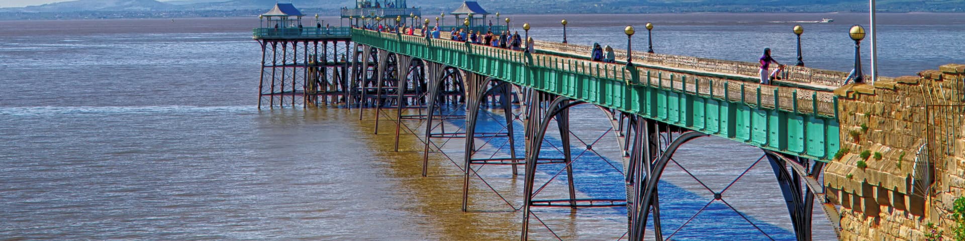 Clevedon Pier was opened in 1869 to receive paddle steamer passengers from Devon and Wales. It is a grade 2 listed building. Sir John Betjerman said it was "the most beautiful pier in England"