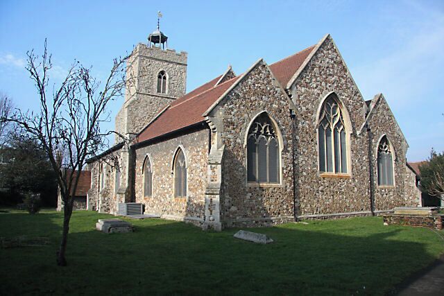 A stone church with a bell tower and arched windows.