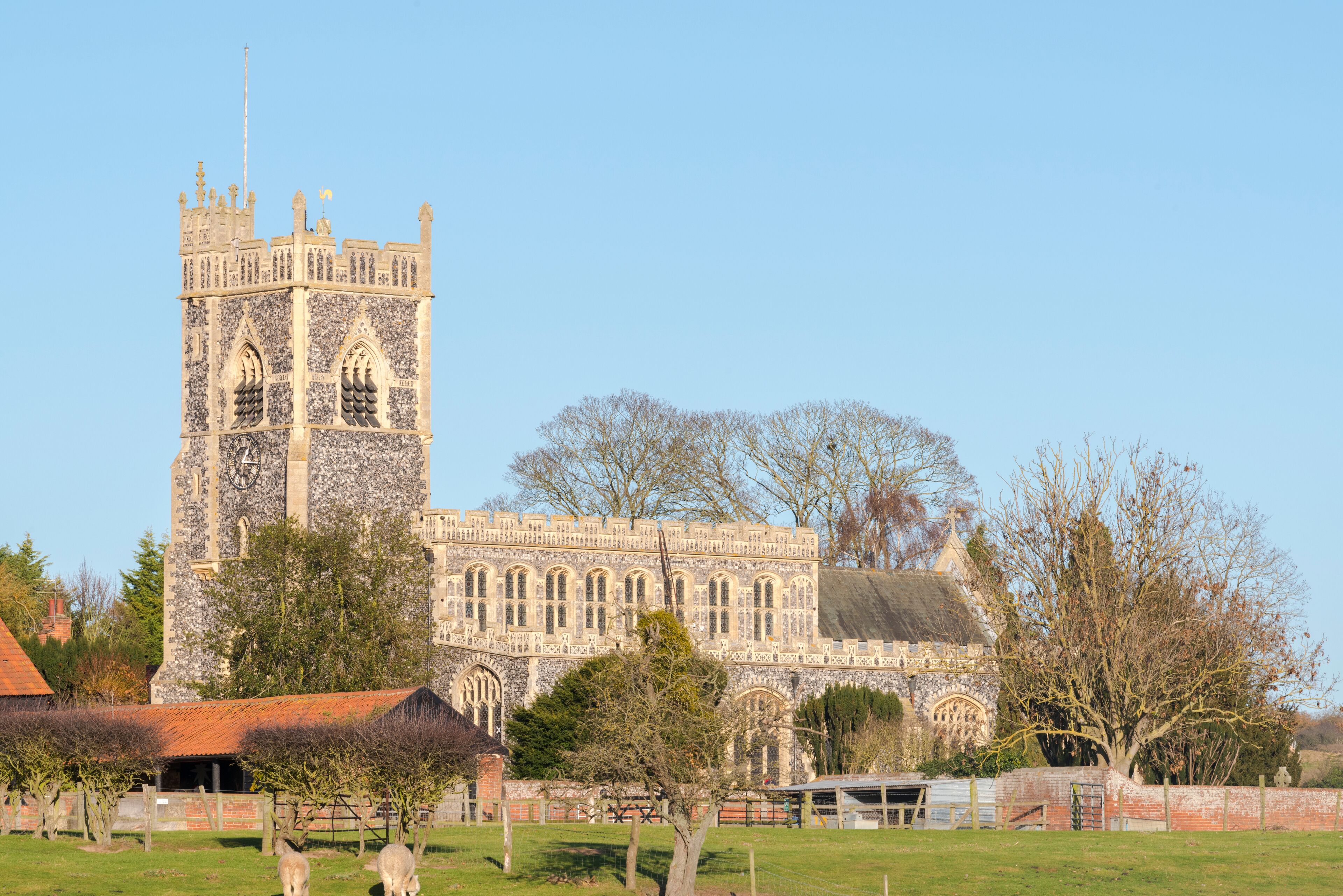 A historic stone building with a clock tower and arched windows.