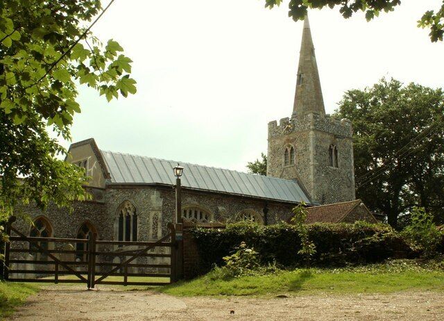 A church with a tall spire and a stone building.