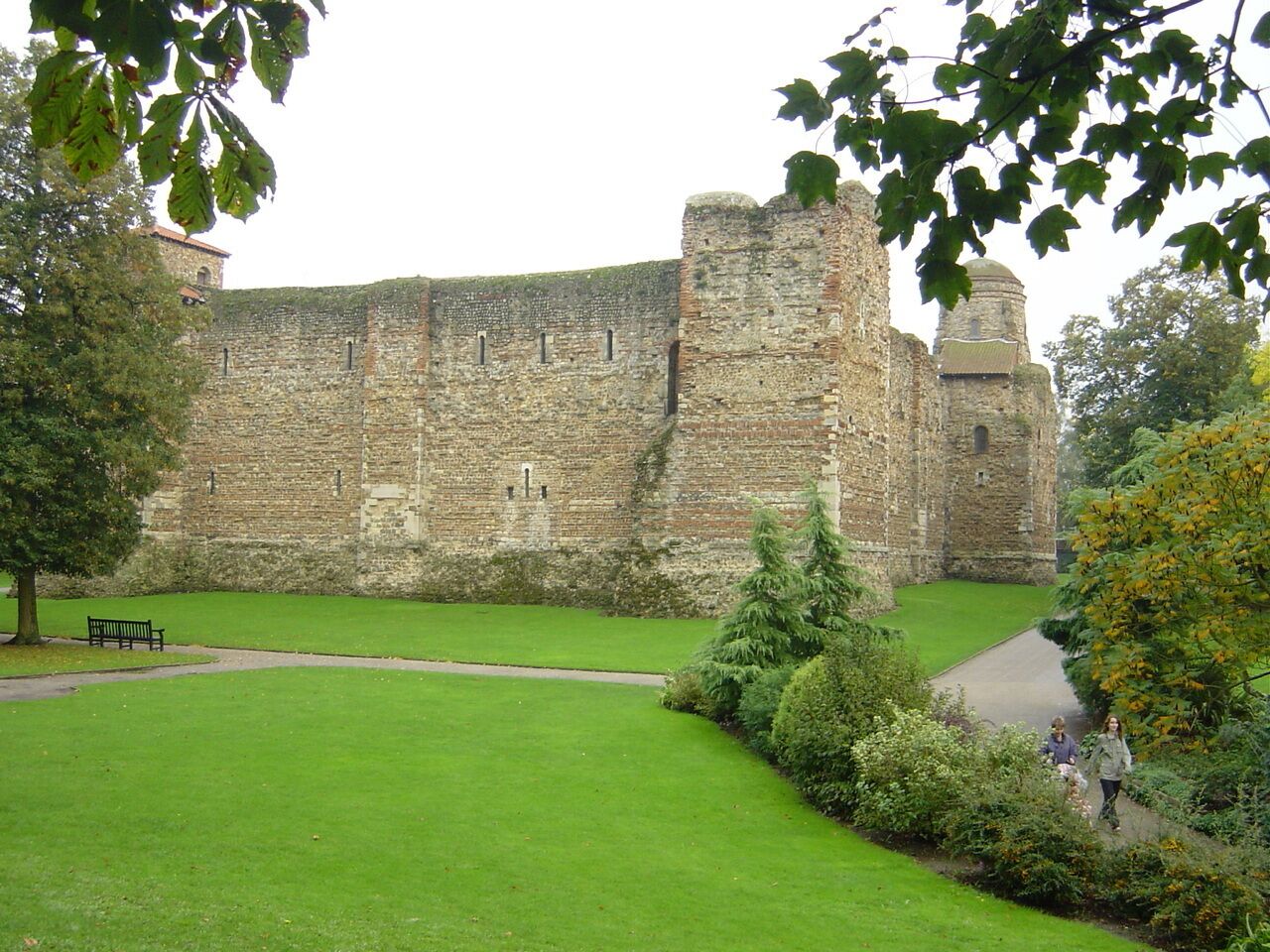 A historic stone castle with a well-maintained lawn and a pathway.
