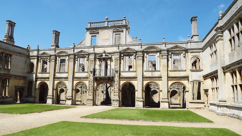 A historic building with classical architecture, featuring arched doorways and columns.