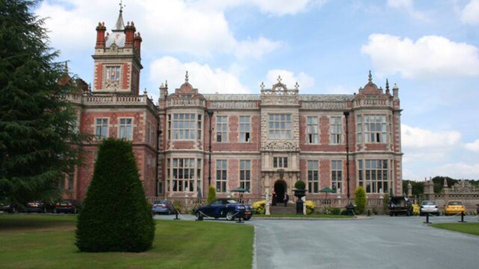 A large, historic building with a prominent clock tower and symmetrical architecture.