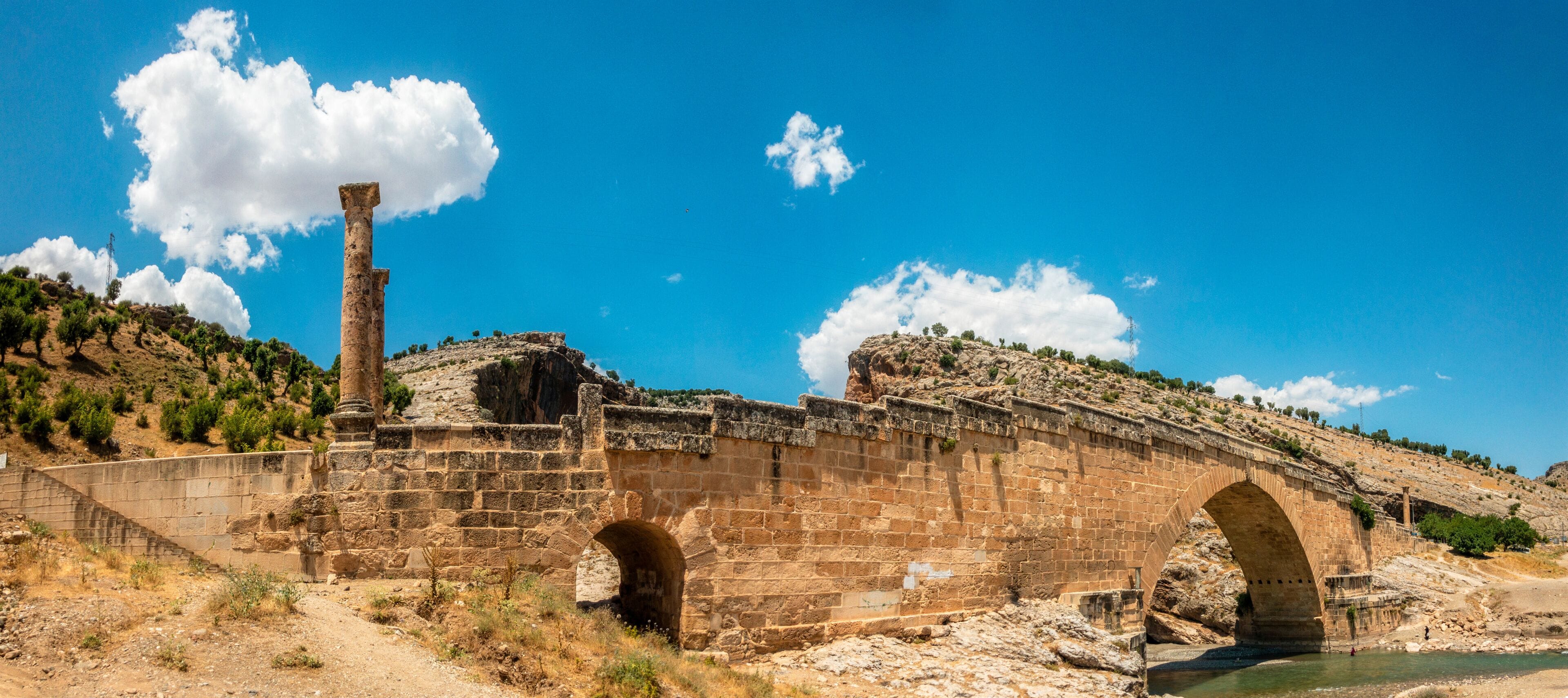 Panoramic view of the Severan Bridge, Cendere Koprusu is a late Roman bridge, close to Nemrut Dagi and Adiyaman, Turkey. Roadway flanked by ancient columns of Roman Emperor Lucius Septimius Severus