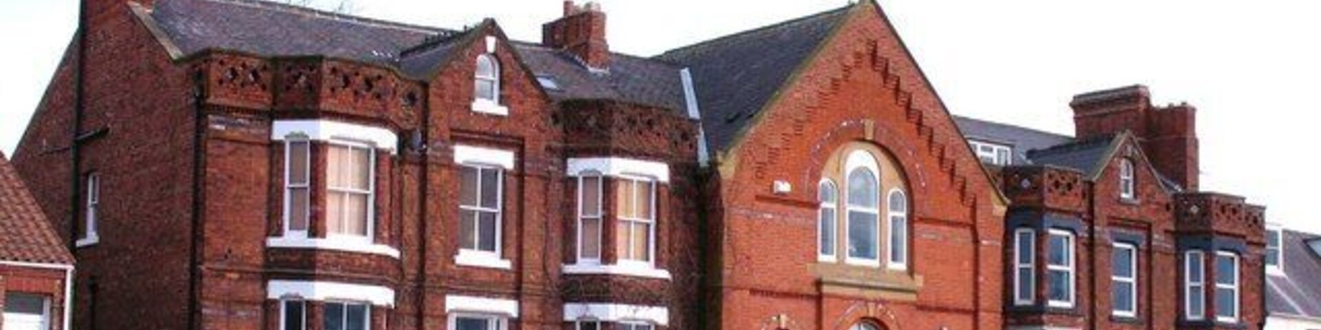 Houses at Middleton One Row A curious group of houses in Middleton. The central section looks as though it should have been a chapel, whilst the 'wings' are of a different brick. Maybe a visitor to the website can throw some light on the history of this block.