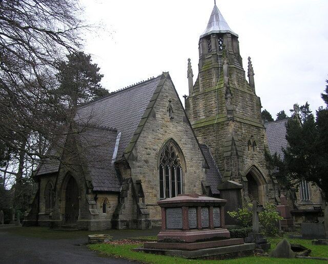 A historic church with a tall tower and arched windows.