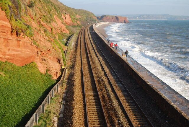 A coastal railway track with cliffs and the ocean.