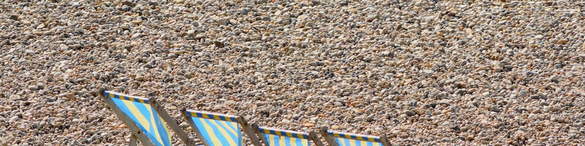 Beach chairs on the pebbles on the Jurassic Coast in Devon