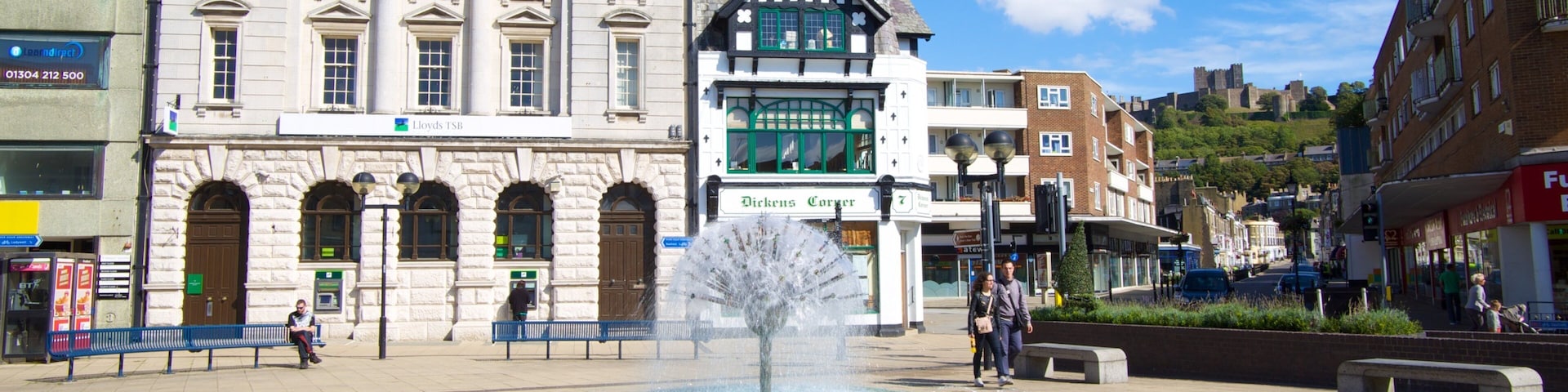 A fountain in a square with historic buildings, including Lloyds TSB and Dickens Corser.