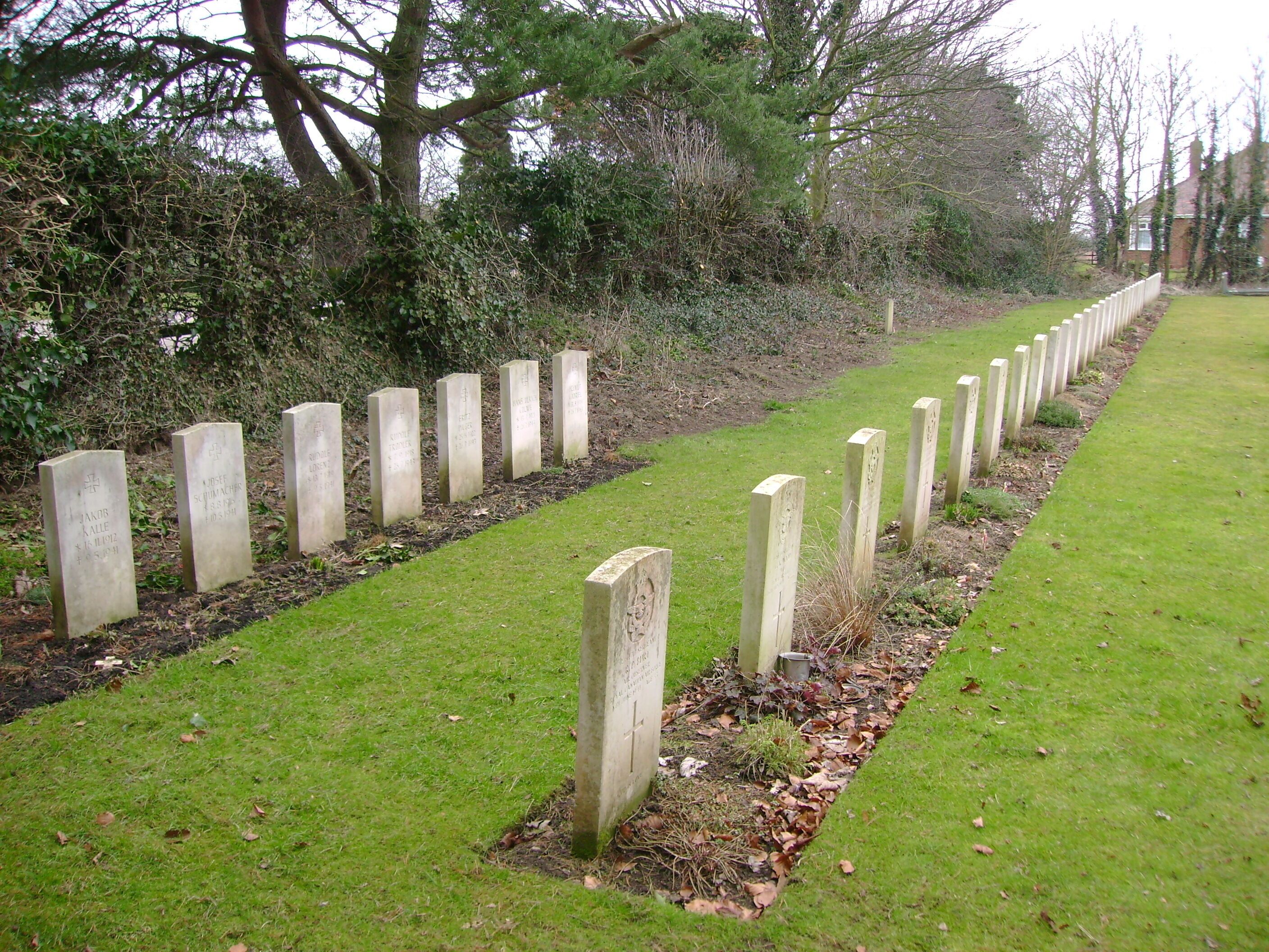 War Graves in Brandesburton Churchyard, Brandesburton, East Riding of Yorkshire, England. Not all the war graves are in this photo, the row on the left contains the graves of thirteen German airmen (all named) The righthand row are Allied airmen (not all named)