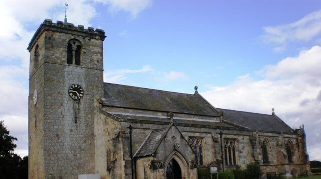 Parish Church, Rudston, East Riding of Yorkshire, England. This shows the parish church of All Saints at Rudston, built of stone in the Norman and Decorated styles. The most ancient part of the church is the Early Norman tower, supposedly erected about 1050.