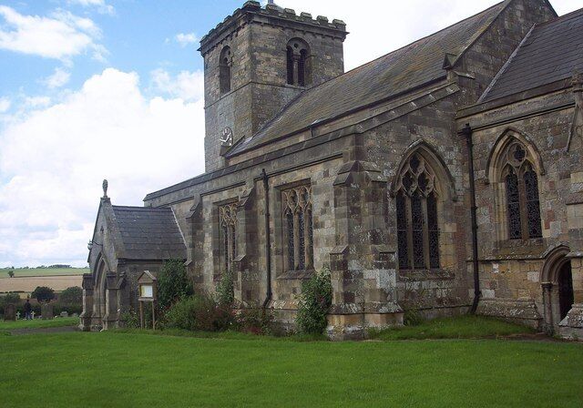 All Saints Church, Rudston, East Riding of Yorkshire, England. All Saints Church is nearly as famous as the Monolith attracting hundreds of visitors each year. It has a 12th Century chancel arch and a Norman tower.