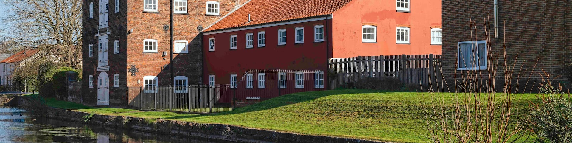 Rear view of ancient, now converted warehouses, and canal head. Driffield, UK.