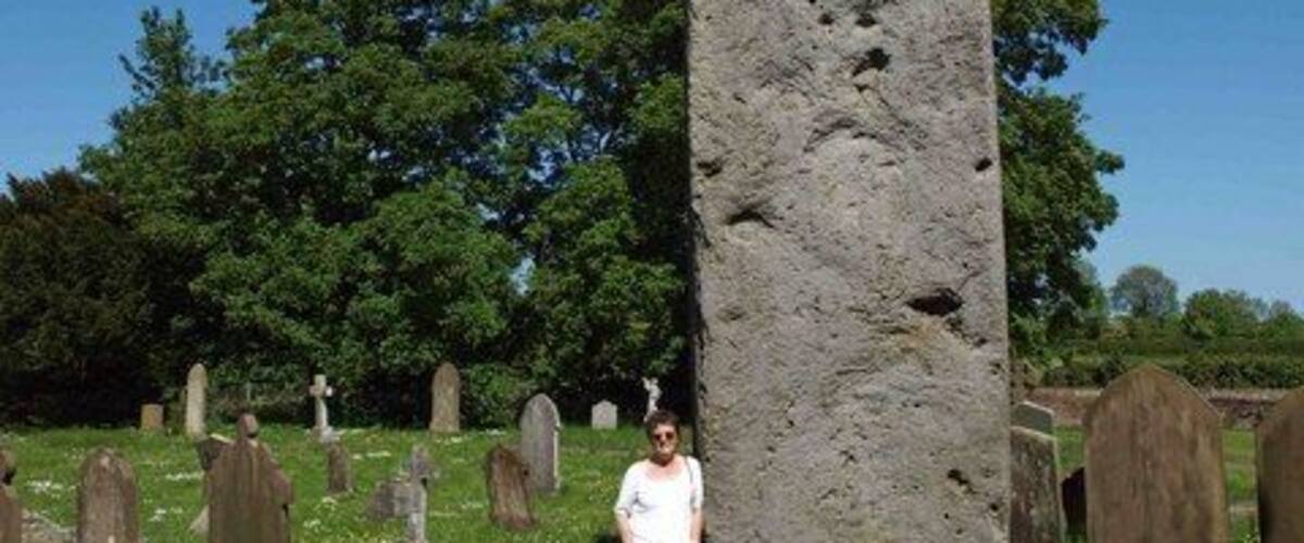 Rudston monolith, Rudston, East Riding of Yorkshire, England. In the Church (All Saints) Yard Rudston. Approximately 8m above ground it is Britain's tallest standing stone. It's weight is estimated at 40 tonnes. In the late 18th century tests revealed that there is as much again of the stone buried in the ground. dating from 2000 BC the stone is believed to come from near Whitby.