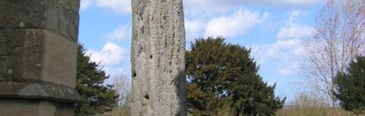 Monolith, Rudston, East Riding of Yorkshire, England. Looking north, showing the narrow face of the stone and its close proximity to the church.