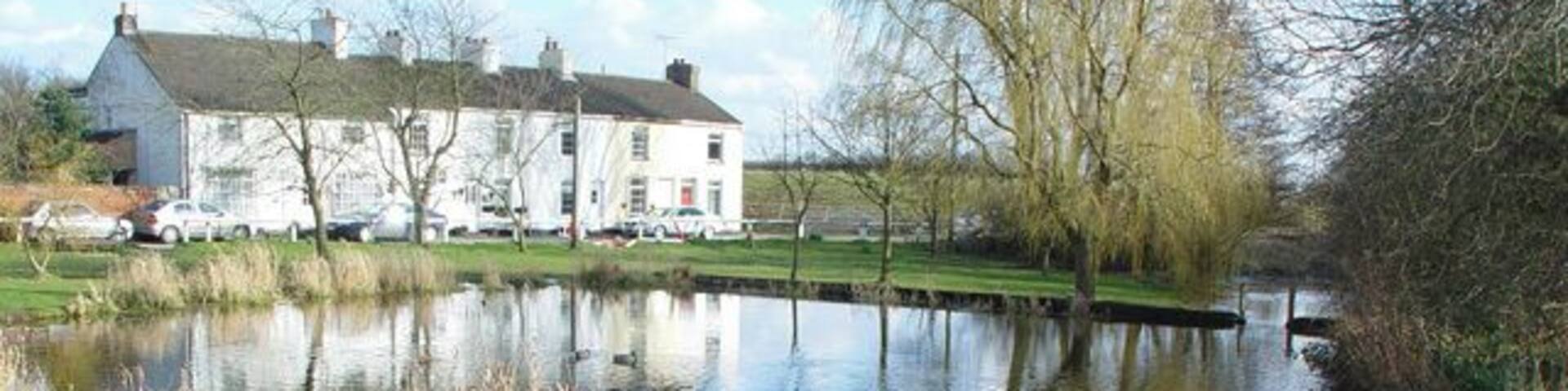 The Duck Pond, Kilham, East Riding of Yorkshire, England. The row of cottages is called "Spring Terrace".