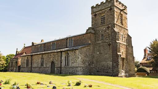 The church dates from the twelfth century onwards, with a 12-13th century chancel, nave with clerestory and north and south aisles, with arcades of five bays and round piers. There is also a western tower, south porch and north vestry. The church is built with Holderness cobbles and limestone from Tadcaster, as well as mediaeval brick. The 13th C. tower is of three stages with a crenellated parapet. There are fragments of t12th C. stonework in the tower, including a reset scratch dial. There are two bells, one dating from the late fourteenth century. The north and south arcades date from the 13th century with one octagonal pier to the north. The chancel arch dates from the fifteenth century. The chancel has a twelfth century blocked priest's door and a squint. The church was enlarged on several occasions in the Middle Ages, in the thirteenth century when the aisles and arches of the nave were enlarged, the fourteenth century when the chancel and porch were enlarged and the fifteenth century when the aisle windows were altered and the clerestory windows added. The tower had decayed by around 1600 and was repaired, but by the mid 19th century the church had deteriorated badly. The chancel was repaired in 1884 and major restoration was carried out from 1889 to 1892 by W. S. Weatherley. This was followed by further work in 1897. There are two Memorial brasses from the fourteenth century. The church has several stained-glass windows.