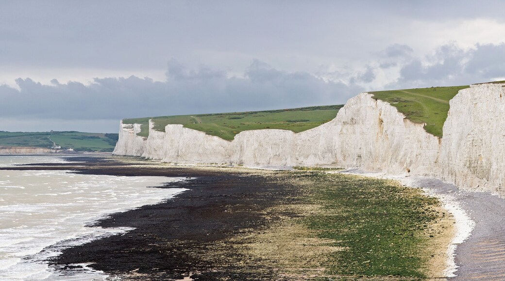 The Seven Sisters, a series of seven chalk cliff peaks along the East Sussex coast in England. Seaford head in the background is on the other side of the River Cuckmere and not part of the Seven Sisters. Taken by myself as a series of 7 frames with a Canon 5D and 70-200mm f/2.8L lens at 200mm.
