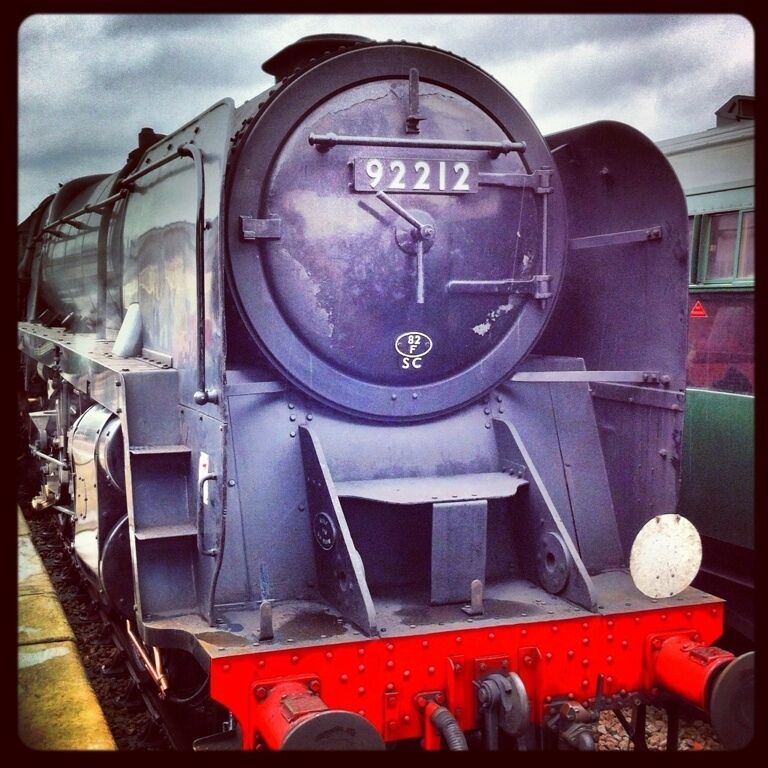 A vintage steam locomotive with the number 92212 on its front.