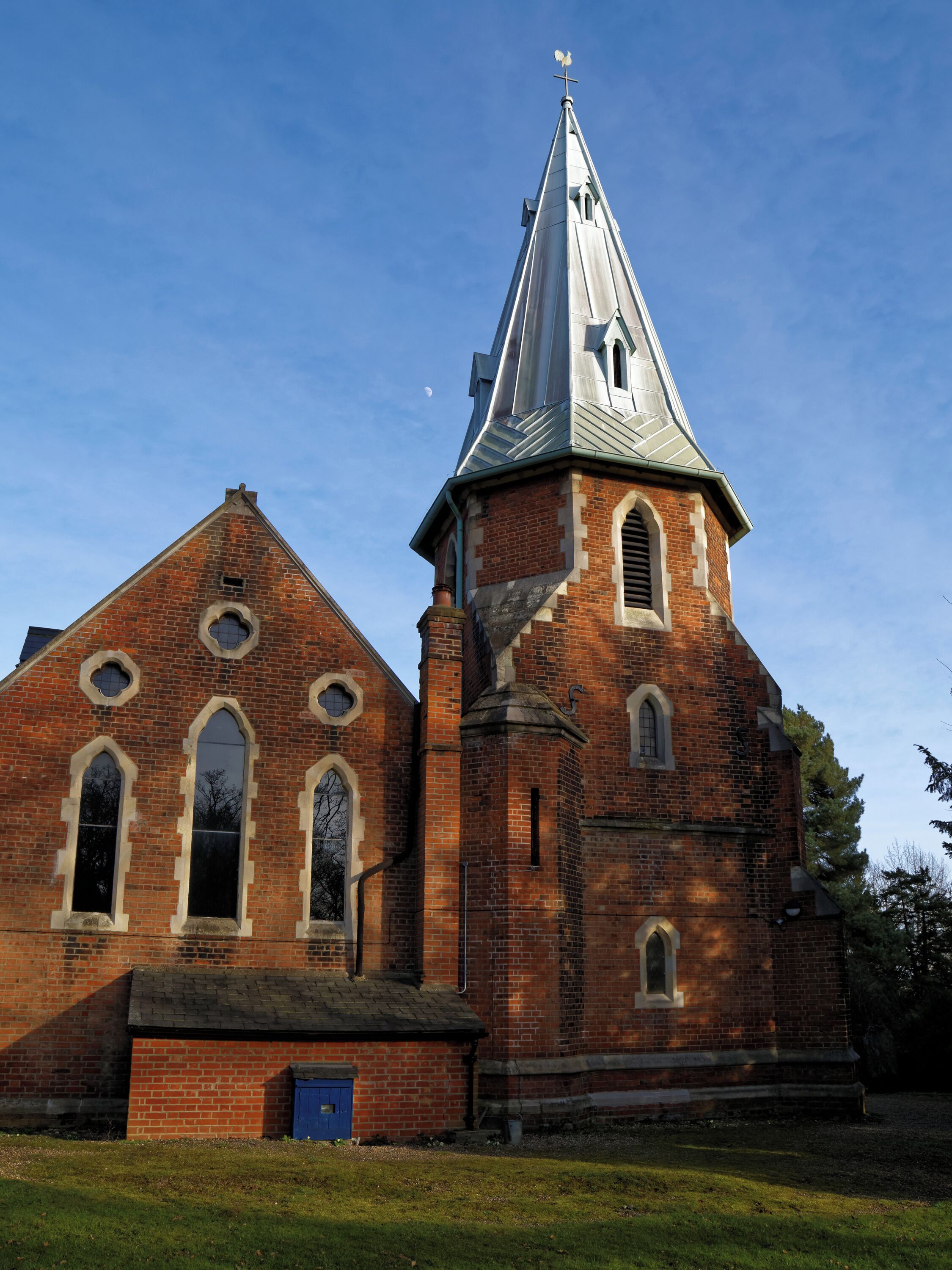 A church with a tall steeple and arched windows.