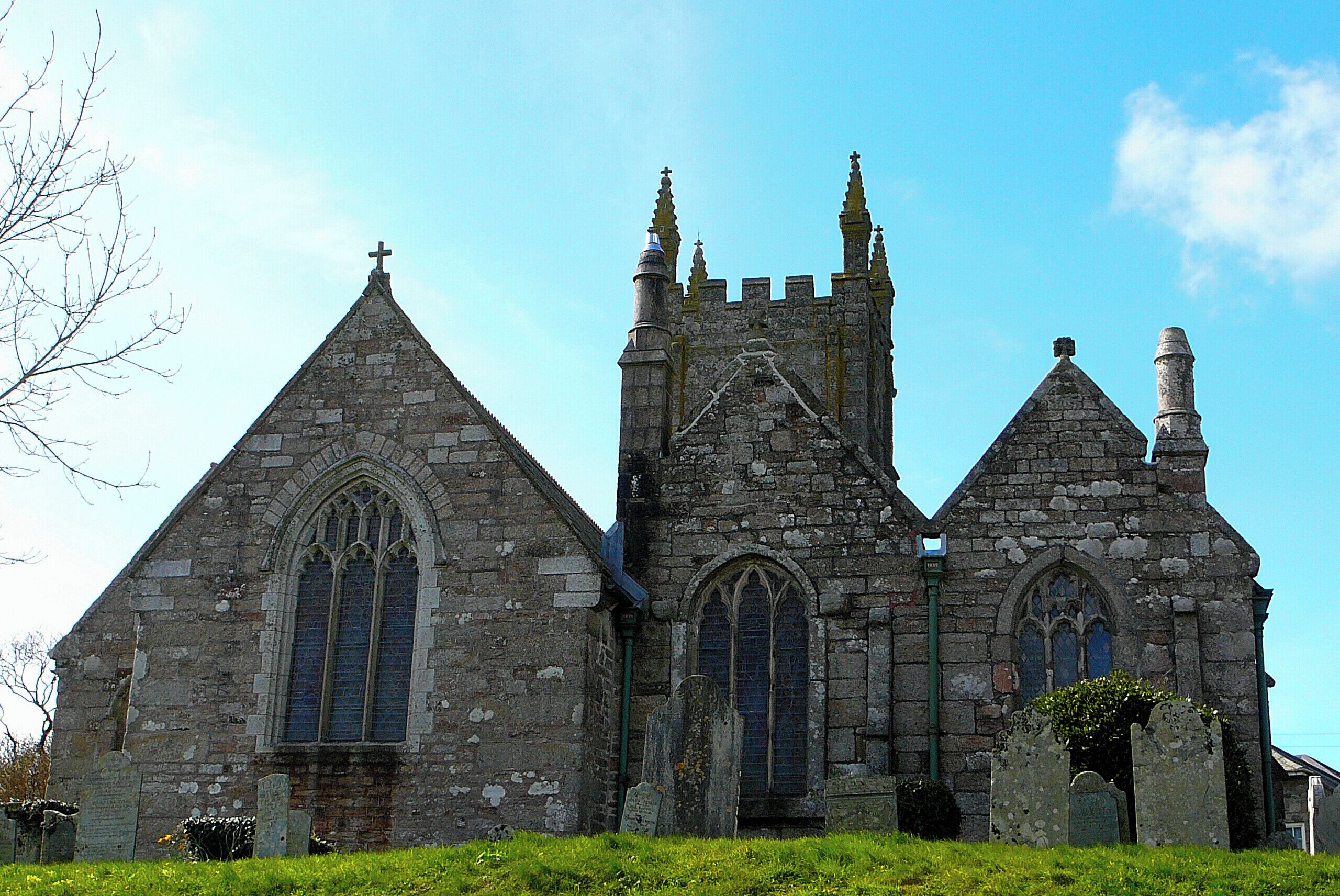 A historic stone church with pointed arches and a tall tower.