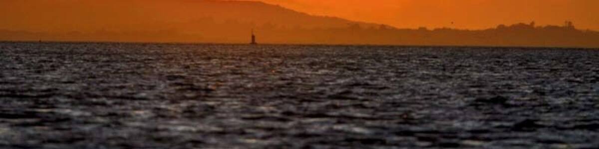 Sunset over the Isle of Wight as viewed from across the Solent at Hillhead harbour.