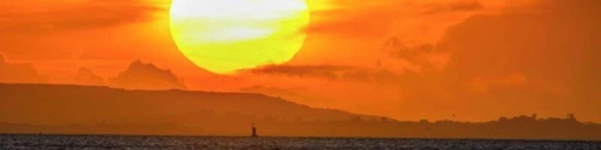 Sunset over the Isle of Wight as viewed from across the Solent at Hillhead harbour.