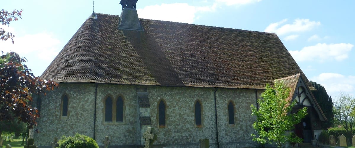A church with a tall steeple and a stone facade.