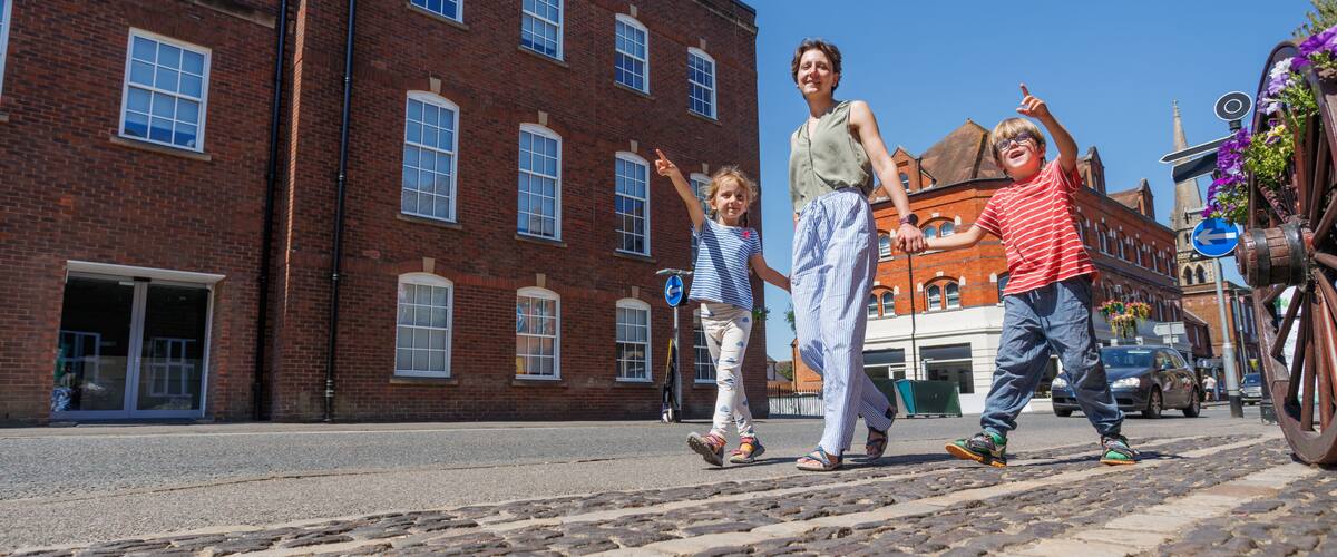 Family of travelers enjoying pleasant sunny walk in Farnham, UK