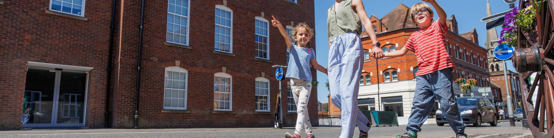 Family of travelers enjoying pleasant sunny walk in Farnham, UK