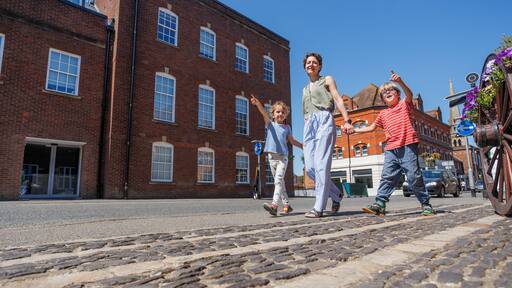 Family of travelers enjoying pleasant sunny walk in Farnham, UK