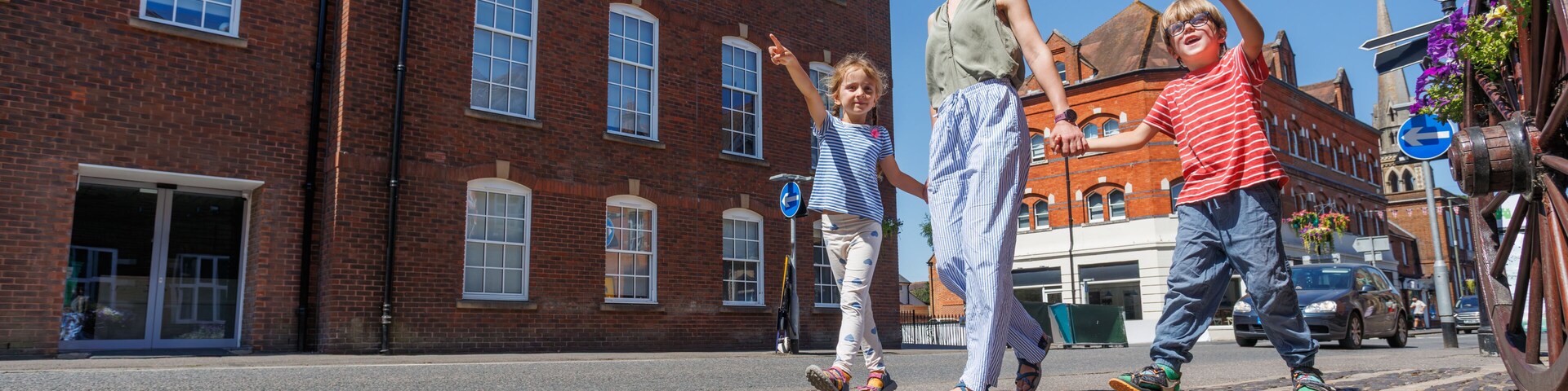 Family of travelers enjoying pleasant sunny walk in Farnham, UK