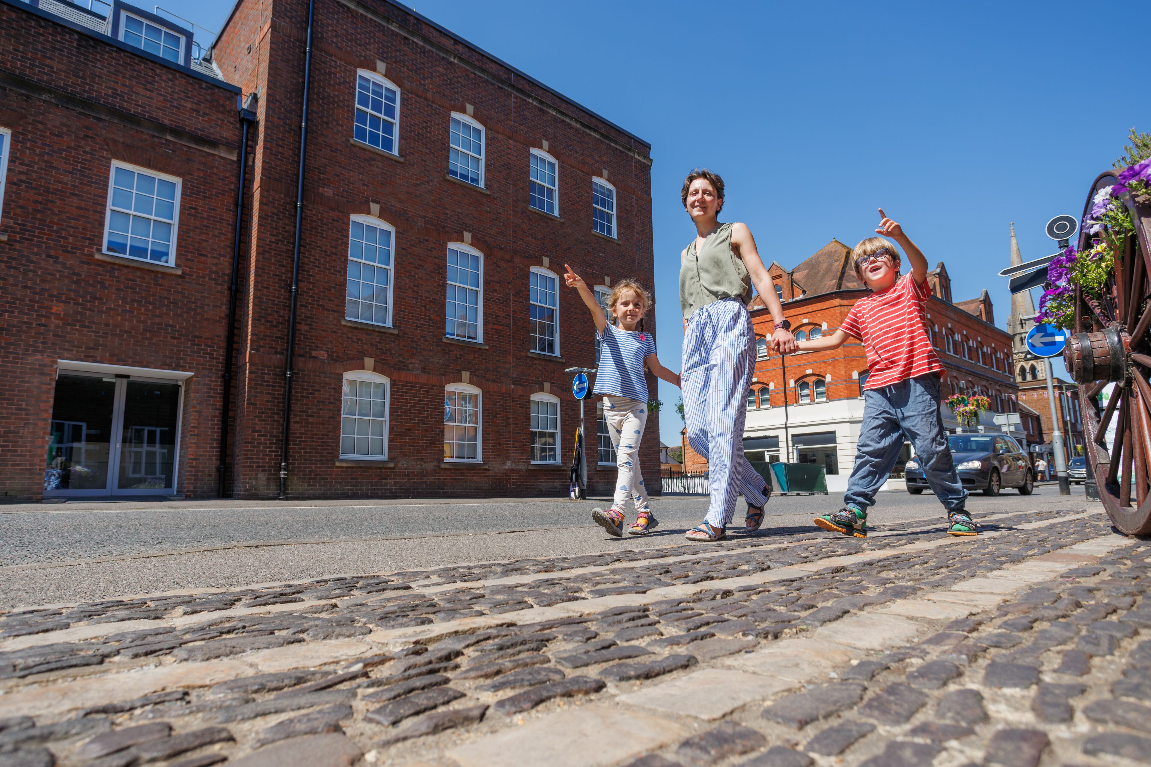 Family of travelers enjoying pleasant sunny walk in Farnham, UK