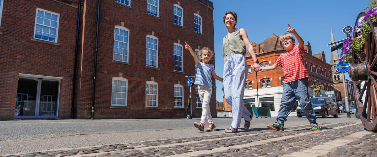 Family of travelers enjoying pleasant sunny walk in Farnham, UK