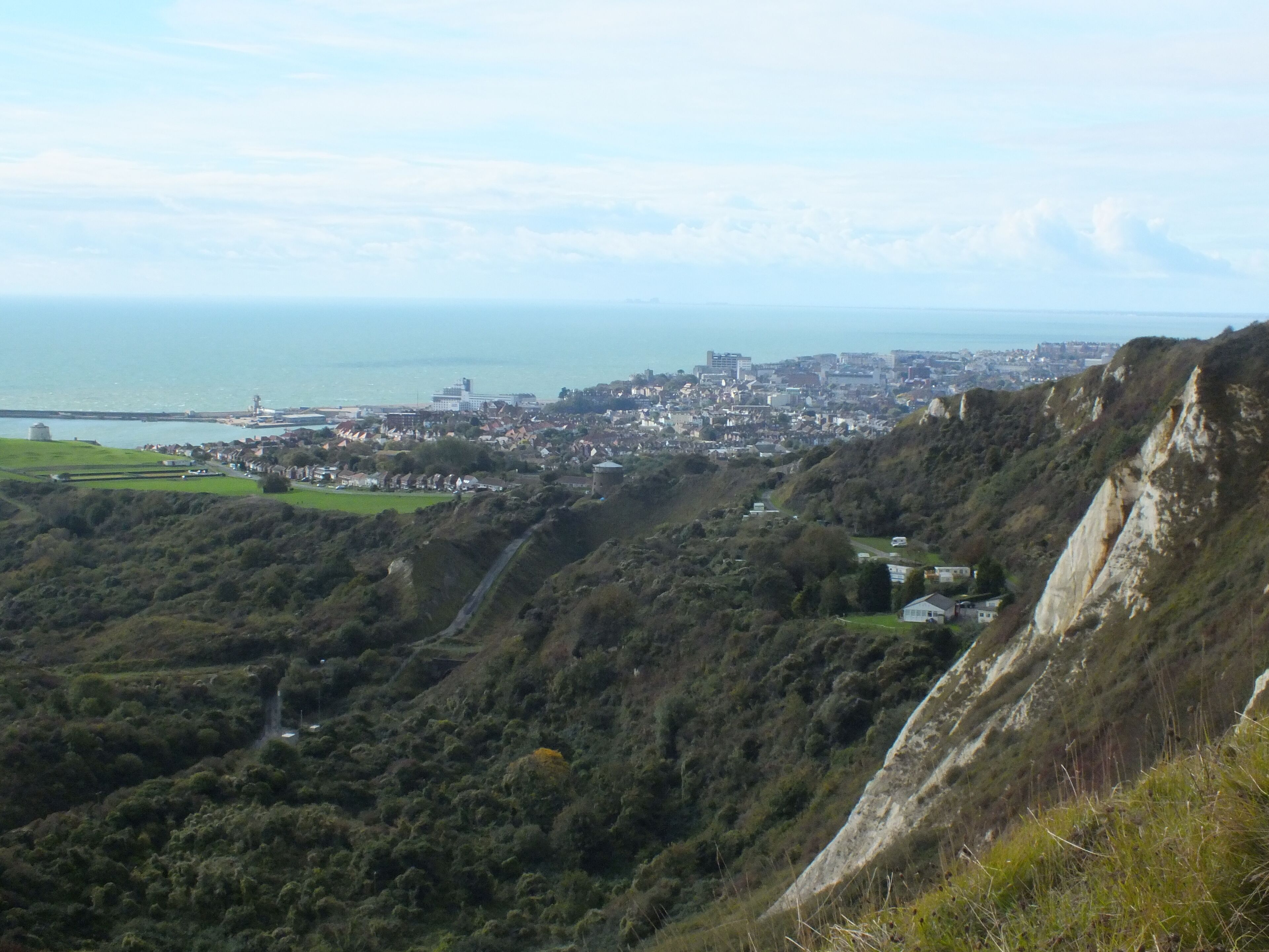 A coastal town with a hillside and a sea view.