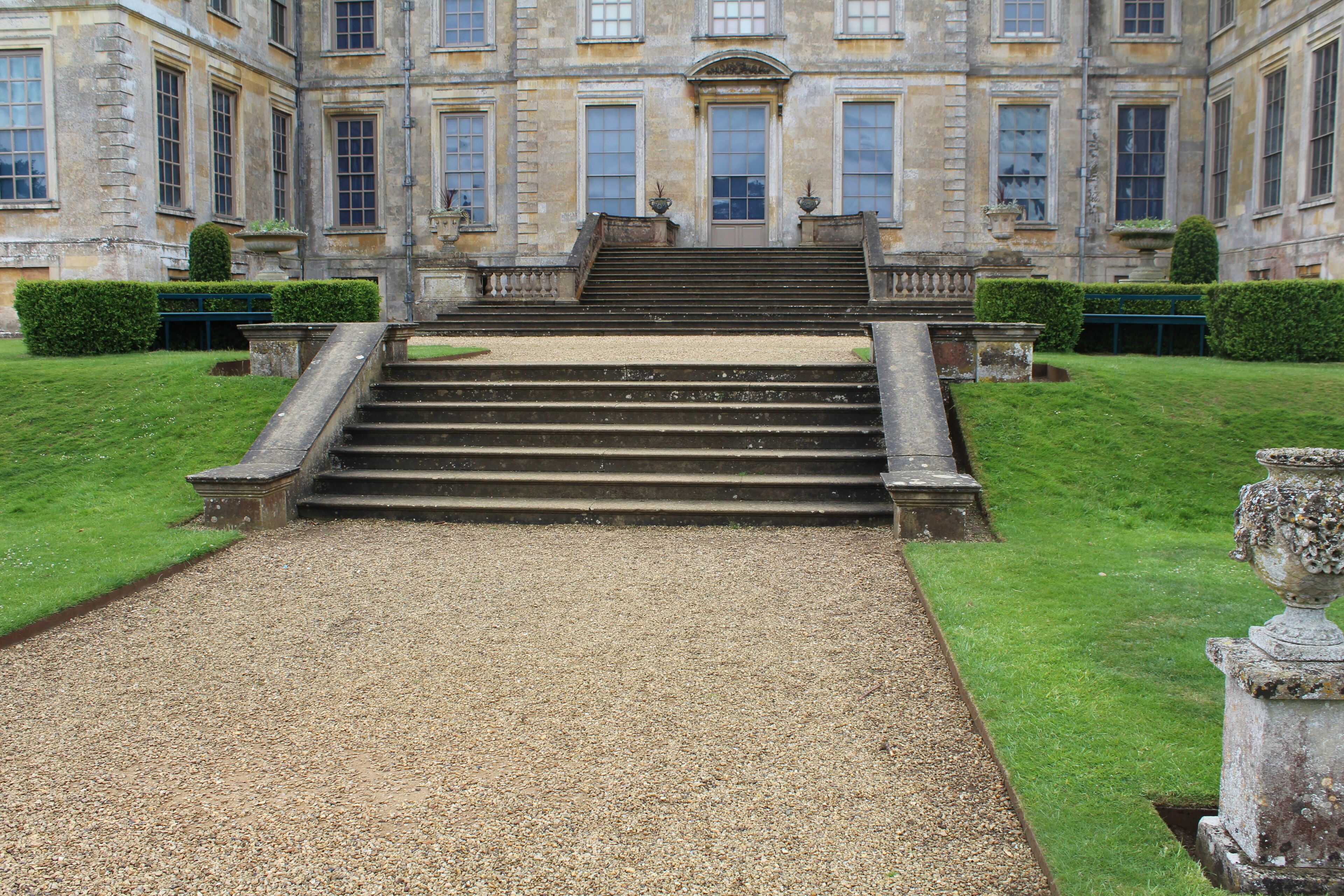 Belton House; steps from the Dutch garden to the north terrace of the house. The statues of Venus and Pallas formerly mounted on the pedestals have been moved to a garden walk east of the house.