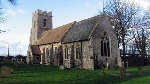A historic church with a tower and arched windows.