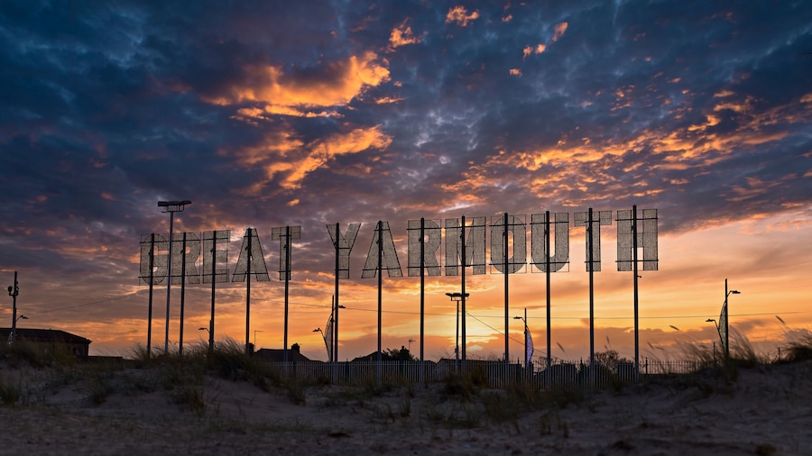 Colourful dramatic sunset landscape with Great Yarmouth sign.