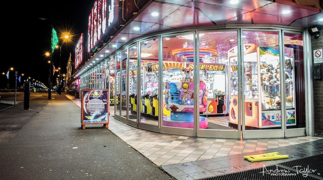 Great Yarmouth Seafront is a great place for an evening stroll , with all the bright colourful lights of the arcades .