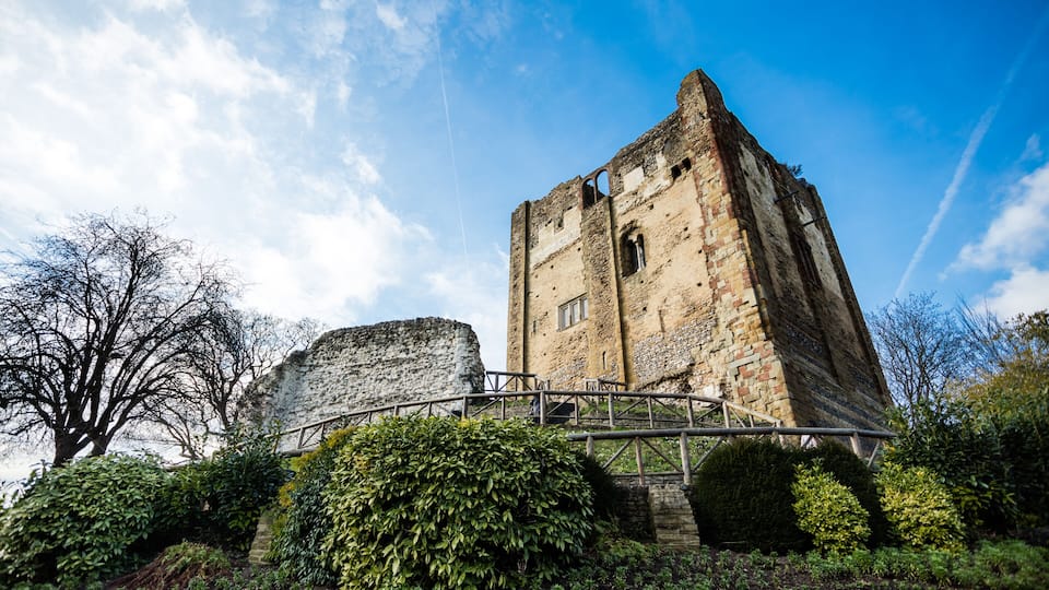 A historic stone tower with a bridge in front.