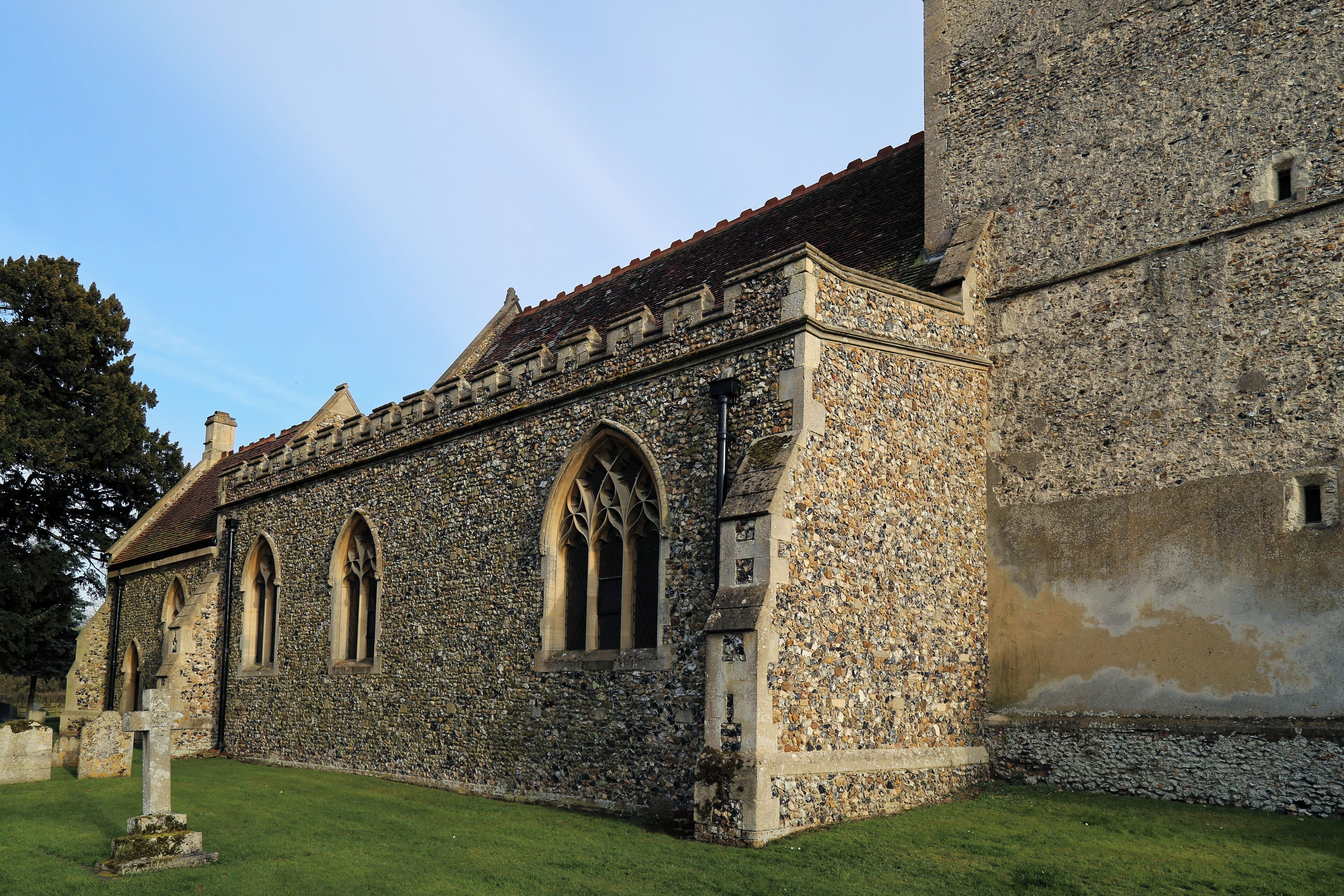 A historic stone building with arched windows and a tower.