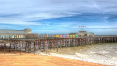 Hastings beach and pier East Sussex England UK in colourful HDR panoramic view