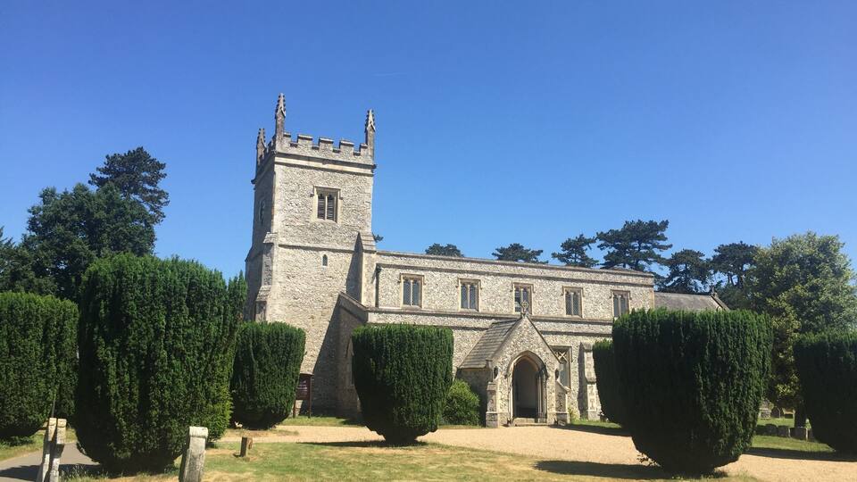 A historic stone church with a tall tower and arched entrance.