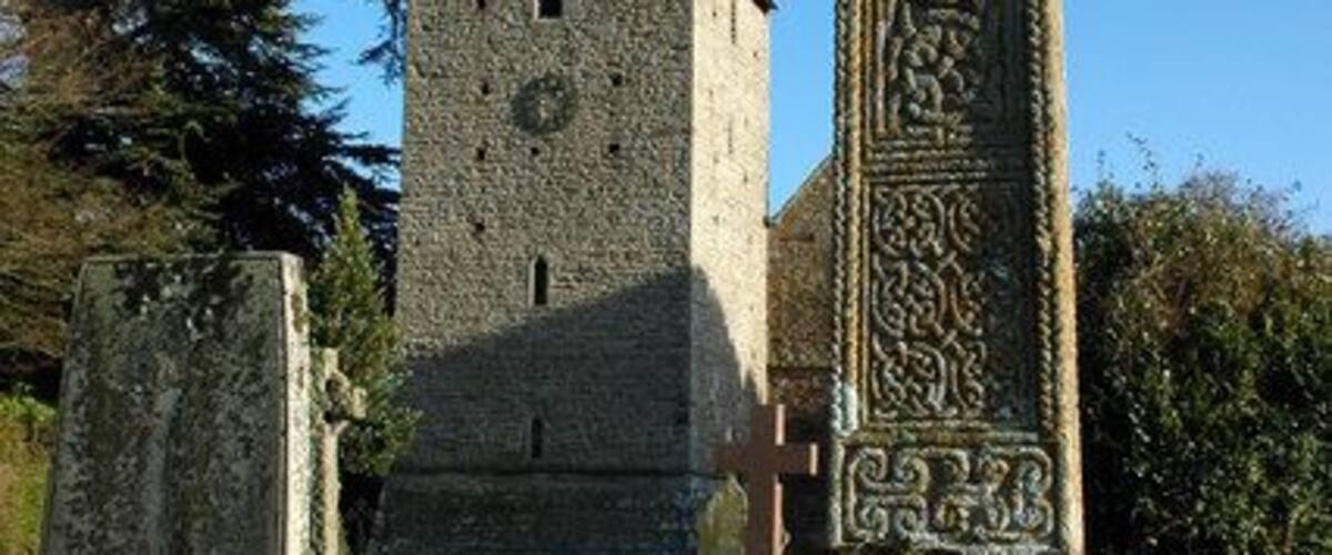 Celtic cross in St James' parish churchyard, Kinnersley, Herefordshire, with the west tower in the background
