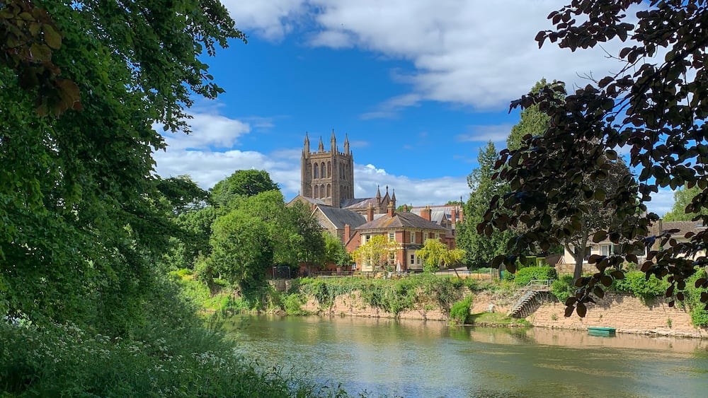 Looking across the River Wye to Hereford Cathedral on a beautiful spring day in Hereford, Herefordshire, UK. A mobile phone photo with some phone or tablet post processing.