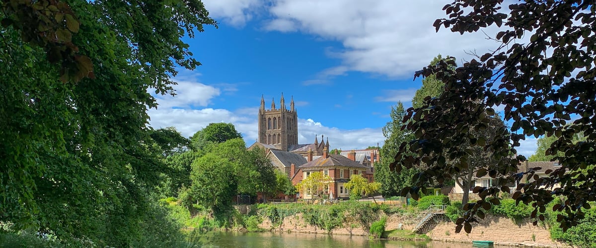 Looking across the River Wye to Hereford Cathedral on a beautiful spring day in Hereford, Herefordshire, UK. A mobile phone photo with some phone or tablet post processing.