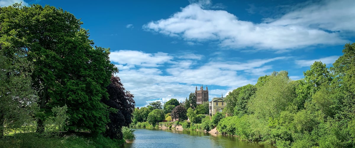Looking across the River Wye to Hereford Cathedral on a beautiful spring day in Hereford, Herefordshire, UK. A mobile phone photo with some phone or tablet post processing.