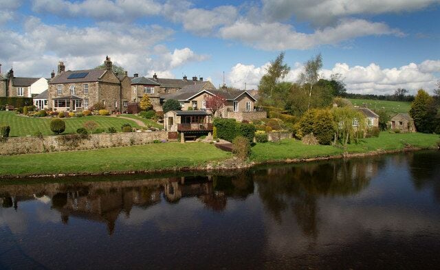 Wark Houses on the side of the River North Tyne at Wark.